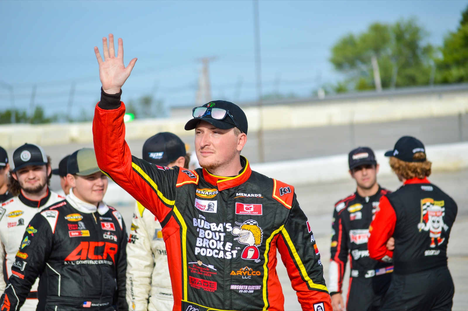 Jackson McLerran waving to the crowd alongside fellow drivers